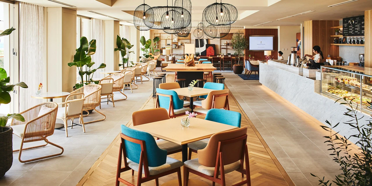 Woven pendant lights, window seating and tables in an Ishigaki resort dining space