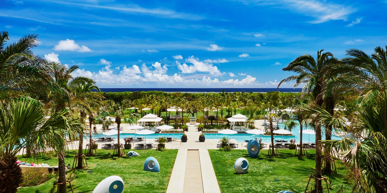 Palm gardens, pools and the distant sea at ANA InterContinental Ishigaki