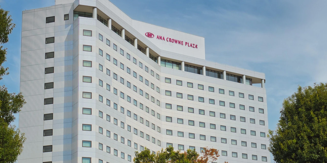 The white tower of ANA Crowne Plaza Narita beneath a blue sky