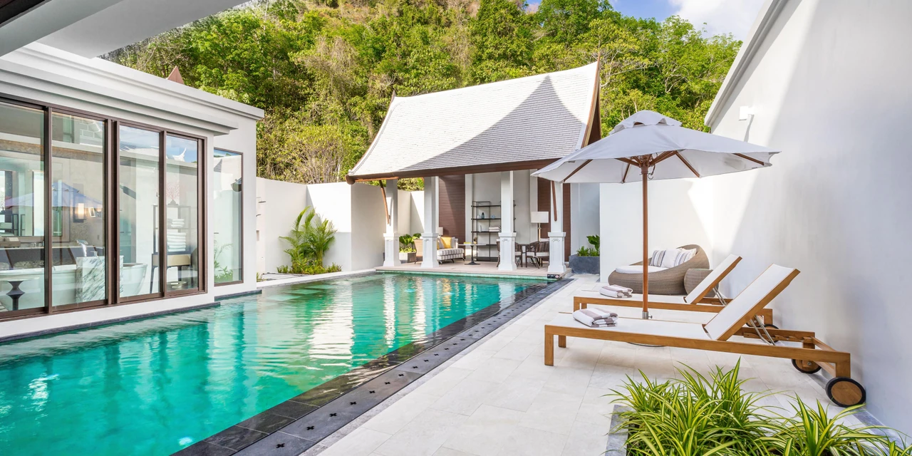 An InterContinental Phuket private pool villa with an outdoor pool and shaded loungers