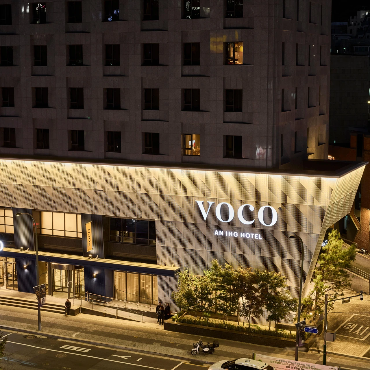 The illuminated entrance and sign of voco Seoul Myeongdong
