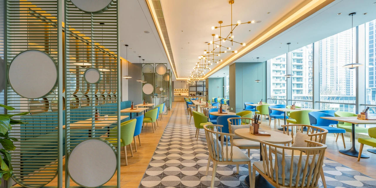 A bright dining space with colourful chairs and buffet counters at EVEN Hotel Suzhou Grand Canal