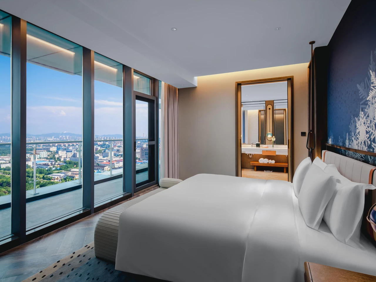 A king room at Indigo Yantai with full-height windows and city views